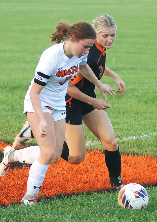 Hillsboro's Ava Pollard (in black) vies for possession near midfield during the Lady Hiltoppers' game against Gillespie on April 29. Pollard scored the first of three first half goals for the Toppers, who went on to win 4-2.
