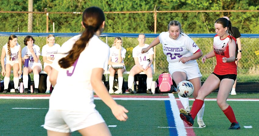Litchfield's Carly Favre dishes off to teammate Avery Stewart to avoid an oncoming Staunton midfielder during the Lady Panthers' game against the Bulldogs on Tuesday, May 7, in Carlinville. Favre is one of six senior soccer players who have helped shepherd the team from a 4-15 record in 2022 to a current record of 13-5 after the Panthers defeated Staunton 2-1 on Tuesday to claim a share of their first South Central Conference championship since 2017.