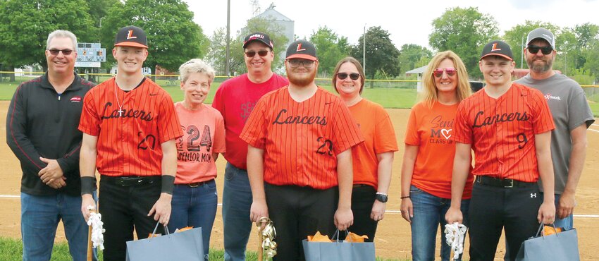 The Lincolnwood-Morrisonville baseball program took time to honor its three seniors before continuing their game with Bunker Hill on Monday, May 6, in Raymond. From the left are Lance Weitekamp, with parents Jean and Jeff Weitekamp; Patrick Lipe, with parents Christina and Jason Lipe; and Gabe Armentrout, with parents Jessica and Gary Armentrout.