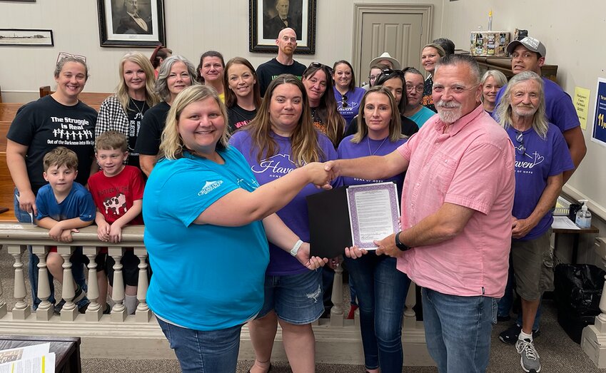 Montgomery County Board Chairman Doug Donaldson, at right, presented a proclamation to members of Cross Over Ministries marking May as Mental Health Awareness Month. In front, from the left are Executive Director Jennifer Carron, Program Director Erica Petcher and Recovery Support Peer Amber Kite. All are employees of Cross Over Ministries that oversee Haven Home of Hope in Hillsboro, Montgomery County&rsquo;s only mental health and substance use crisis center.