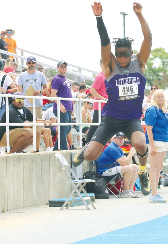 With his coaches Anthony Robinson and Jeremy Palmer watching from the rail, Litchfield's Keenan Powell makes his first jump in the triple jump at the IHSA Class 1A Boys State Track and Field Championships in Charleston on May 23. Powell went 45'10&quot; on his first jump, which would have been enough to win the championship, but just for good measure, the recent grad went ahead and uncorked a 46'8&quot; jump on Saturday in the finals to seal Litchfield's first state title since 1980.
