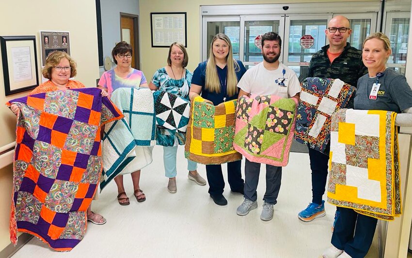 Pictured above, from the left are quilters Becky Gonzalez and Lisa Finley with Hillsboro Health team members Theresa Rapp, Alayna Hutchison, Ben Rapp, Rhett Eskew, Tracy Stenroos. Not pictured is Marti Benning.