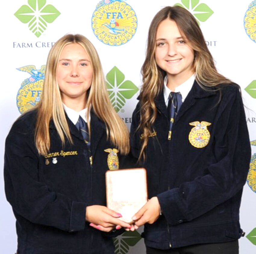 From the left, Summer Spencer and Fallon Knodle hold the Growing Leaders National Chapter Award section winner plaque.