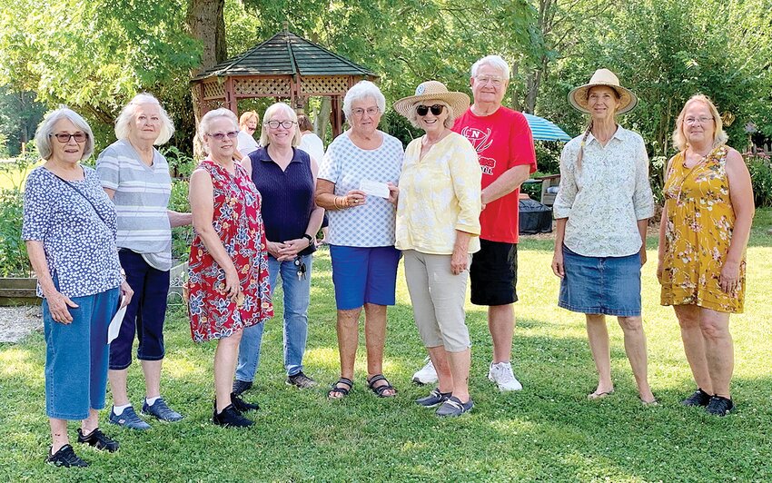 Several members of the Montgomery County Garden Club traveled from Litchfield and Hillsboro to attend the Nokomis Garden Walk. While enjoying Jim and Margie Eisenbarth&rsquo;s back yard garden, they presented a $50 donation to the library to Margie, president of the Nokomis Public Library board of&nbsp;trustees. Pictured above, from the left, are Jody Dunn, Maxine Milanos, Rhoda Gipson, Nancy Snyder, Nancy Jones, Margie and Jim Eisenbarth, Barbara Ramsey and Virginia Voyles.&nbsp;