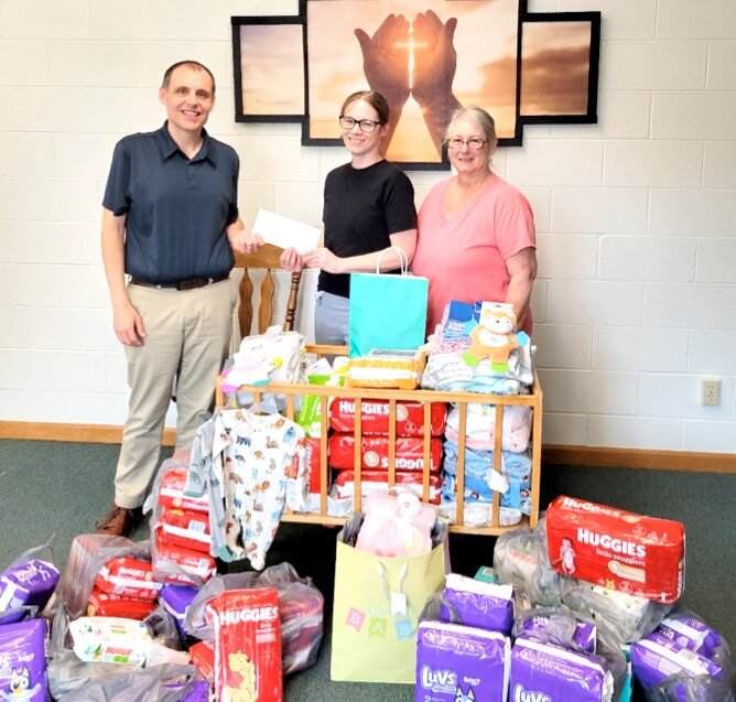 Pictured above are Calvary Baptist&rsquo;s pastor, The Rev. Mike Plummer, Lighthouse Pregnancy Center representative AnneMarie White and April Leetham, Calvary&rsquo;s Women&rsquo;s Ministry Team Leader.
