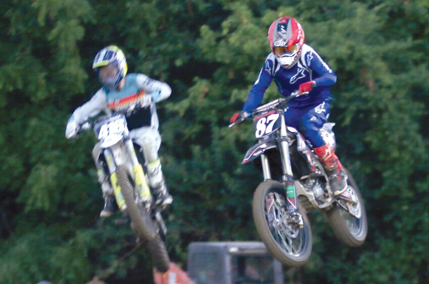 With #418 Ace Enloe closing in, Keegan Pickard goes over one of the jumps at the Montgomery County Fair motocross event on June 21, in Butler. Enloe finished fifth in both the 250 Pro and 450 Pro classes, while Pickard was eighth in 250 and ninth in 450.