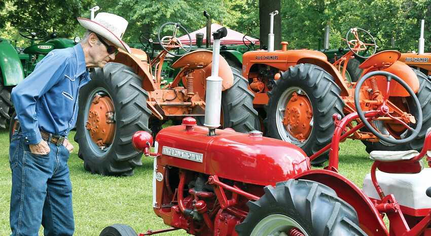 It was a warm one at the Olde Tyme Tractor Show in Hillsboro on July 13 and 14, but there were also plenty of antique tractors to check out, now matter what brand you preferred. Above, Larry Tucker of Butler takes a gander at Andy Theriac's International Cub during the show on Saturday, July 13, at the Hillsboro Fireman's Clubhouse.