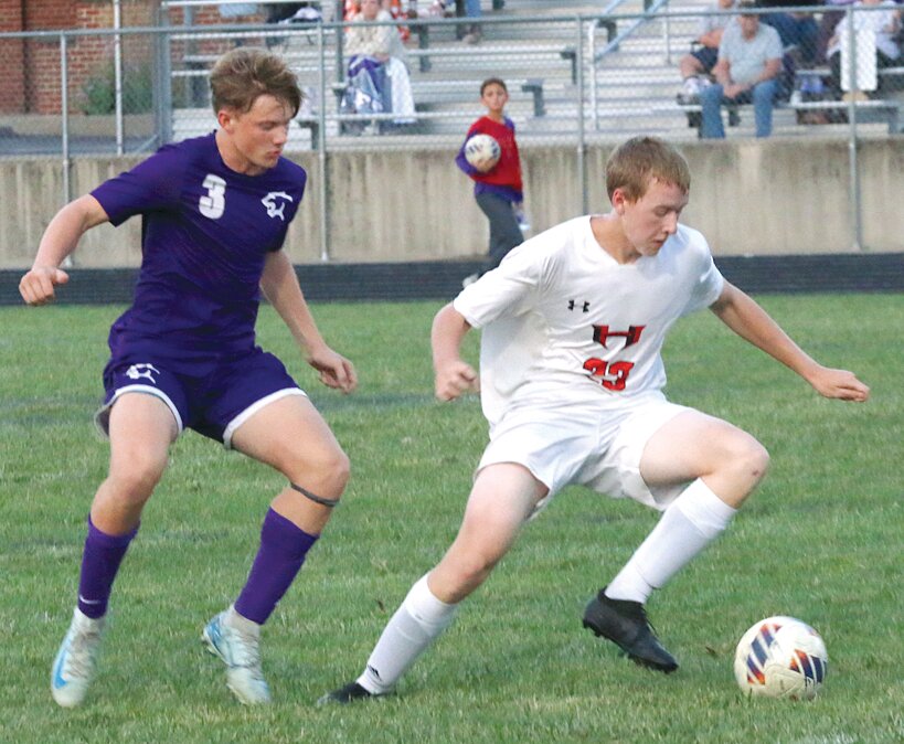 Litchfield's Brody Dykema looks for an opportunity to get the ball away from Hillsboro's Will Yeske during the South Central Conference clash in Litchfield on Tuesday, Sept. 24. The Toppers scored twice in the first half and three more times in the second to pick up a 5-1 win over the Panthers.