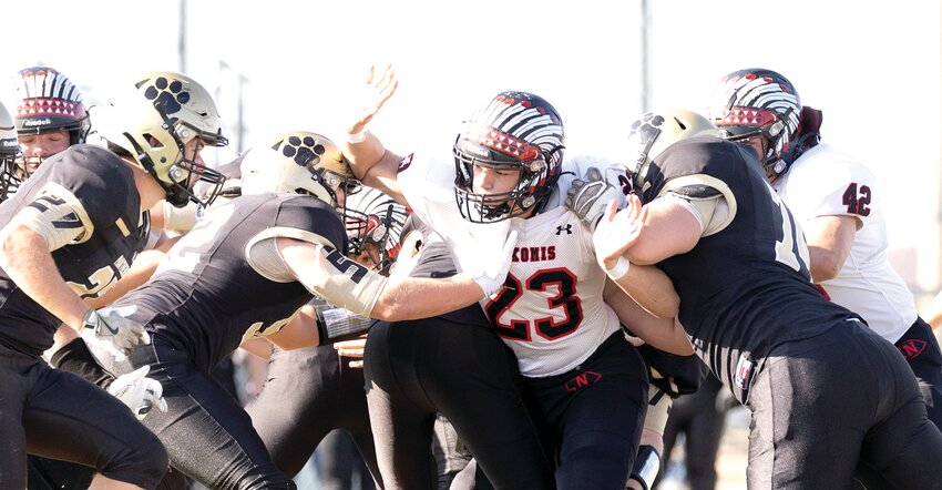 Nokomis' Drake Taylor (#23) fights his way through the Camp Point Central offensive line during the Redskins' playoff game in Camp Point on Saturday, Nov. 2. Taylor and the Nokomis defense held the Panthers to their second lowest rushing total of the season, but the defending Class 1A state champions were equally stout on the defensive end and moved on with a 34-6 victory.