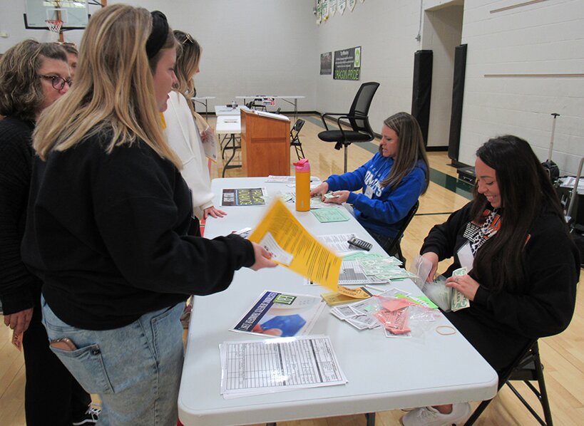 Pictured above, a participant visits the &ldquo;EBT Station&rdquo;, which is a place where participants can access food stamps based on their allotted allowance, as part of the Community Action Poverty Simulation.