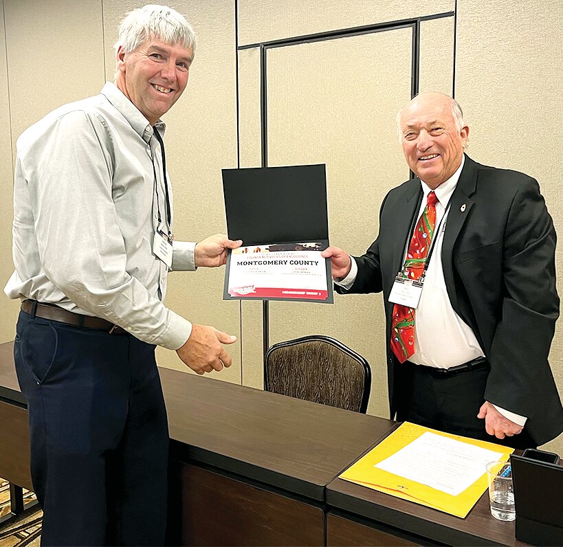 Pictured above, Montgomery County Farm Bureau President, Dennis Hand, at left, accepts a Certificate of Achievement of IAA District 14 Director, Ken Cripe, at right.