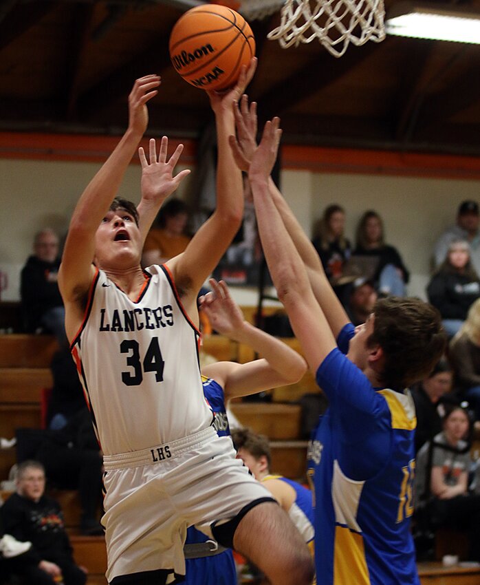Lincolnwood's Drew Gilpin goes to the hoop for two of the Lancers' 54 points in their win over Tri-City on, Jan. 24.