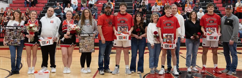 Three senior basketball players and two senior cheerleaders were recognized for their contributions before the start of Nokomis&rsquo; MSM Conference game against Calvary on Saturday, Feb. 8. From the left are Marcie Carroll, with parents Misty Combs and Matt Combs; Jahna Guinn, with mom Janelle Jaros; Atticus Bertolino, with parents Adam Bertolino and Meghan Bertolino; Ian Keller, with parents Sheila and Paul Keller; and Drake Taylor, with parents Vanessa Taylor and Randy Taylor.