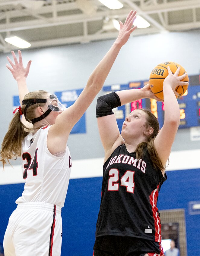 Calhoun's Kate Zipprich (34) and Nokomis' Kinley Stolte (24) battled for much of the regional championship in White Hall on Friday, Feb. 21. Stolte didn't let the Warriors' length and athleticism faze her, scoring a team-high 18 points, but Zipprich made the most of her opportunities as well, scoring 13 points, including six on offensive rebounds, as Calhoun pulled away late for a 53-37 win.