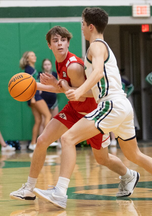Nokomis' Kannon Jonas looks for a way around Blayzz Verdeyen of Windsor/Stew-Stras during the Redskins' regional opener in Strasburg on Monday, Feb. 24. Jonas led Nokomis with 14 points, including four free throws in the fourth quarter, to help the Redskins come away with a 56-42 victory over the Hatchets.