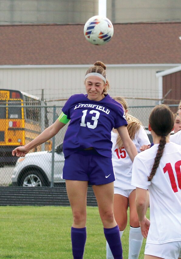 Litchfield's Daphney Hartel goes up for a header off a corner kick during the first half of the Lady Panthers' game against Waterloo Gibault on Friday, March 28. Hartel later scored Litchfield's only goal in a 5-1 loss to the Hawks that ended Litchfield's unbeaten streak after four games.