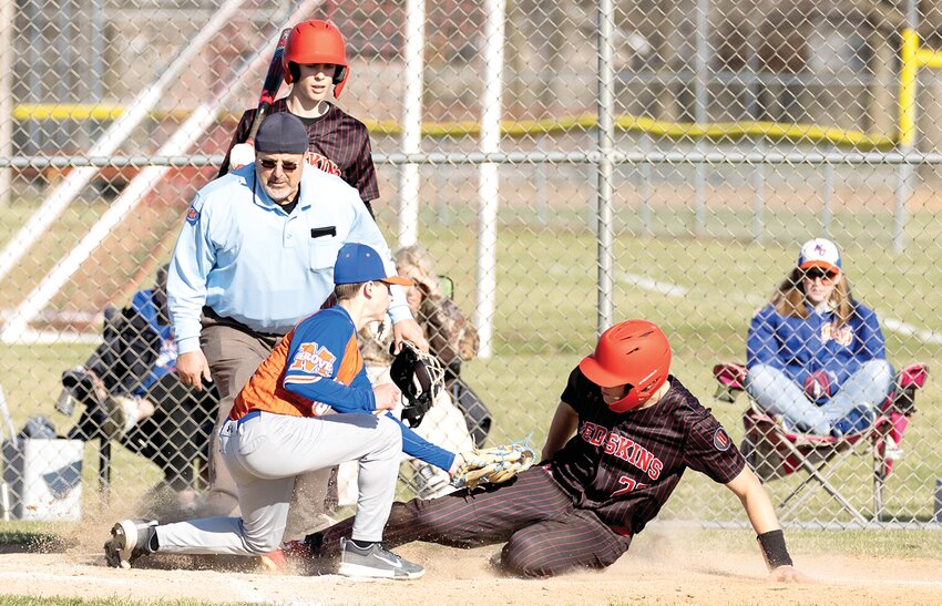Nokomis senior Drake Taylor slides in safely at home during the Redskins' home game against Mulberry Grove on Wednesday, March 26. The run was one of 15 Nokomis scored against the Aces as they scored their third win of the season, 15-0, in four innings.