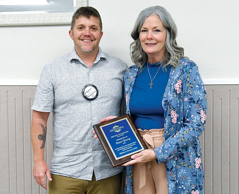 Hillsboro Sertoma Club President Tyson Holshouser, at left, presents this year&rsquo;s Service to Mankind Award to Dawn Young of Hillsboro.