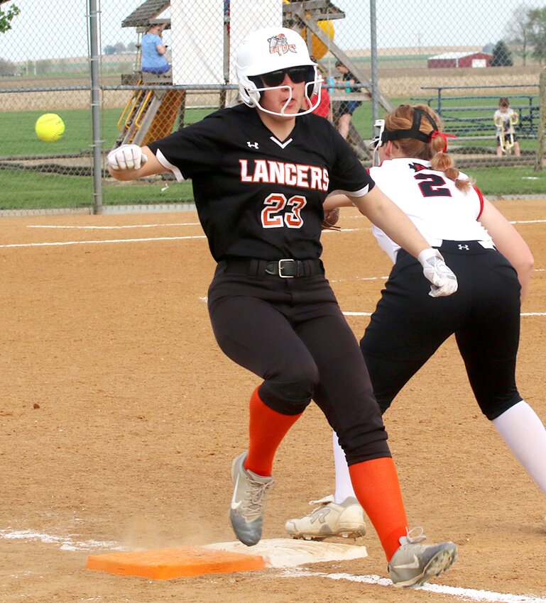 Lincolnwood/Morrisonville's Ella Jenkins beats Kalasandra Cook's throw to Cloey Dirks at first by a step during the fifth inning of the Lancers' game in Raymond against Nokomis on Thursday, April 24. Jenkins scored two batters later as part of a four-run inning for Lincolnwood, who won 5-0 over the Lady Redskins.