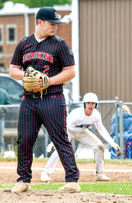Nokomis pitcher Levi German sneaks a peak at Litchfield's Titan Hires during the intra-Montgomery County scrap on the Panthers' home field on Saturday, April 26. German allowed just five hits and one earned run, but Hires and the Purple Panthers came away with a 4-1 victory.