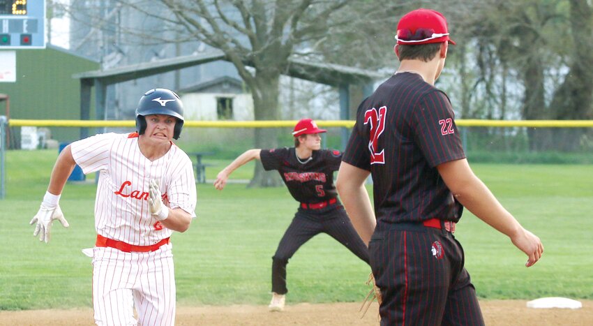 With Nokomis shortstop Kannon Jonas set to make the throw to first behind him, Lincolnwood/Morrisonville's Jhude Walker hustles his way to third during the Lancers' home game against the Redskins on Thursday, April 24. Nokomis kept Walker from scoring in the inning, but weren't so fortunate earlier in the game as the Lancers picked up a 5-2 victory for their fifth MSM Conference win of the season.