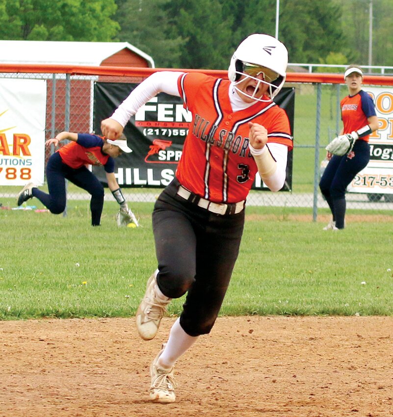 Hillsboro's Briley Kirby sprints toward third base after a double by Lainey Lessman in the fifth inning of the Toppers' game against Pana on May 5. Before the Pana centerfielder can pick up the ball, Kirby was already on the way home, scoring Hillsboro's third run of the inning.