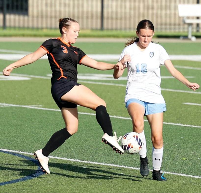 Hillsboro&rsquo;s Gracie Chambers volleys a ball toward the North Mac side of the field before the Panthers&rsquo; Kathryn Buckellew can close in during the regional semifinal game at Quincy Notre Dame on May 16. The Toppers picked up a late second half goal from Reagan Lentz to beat North Mac for the third time this year, earning them a shot at Quincy Notre Dame on Tuesday, May 20, in the regional championship.