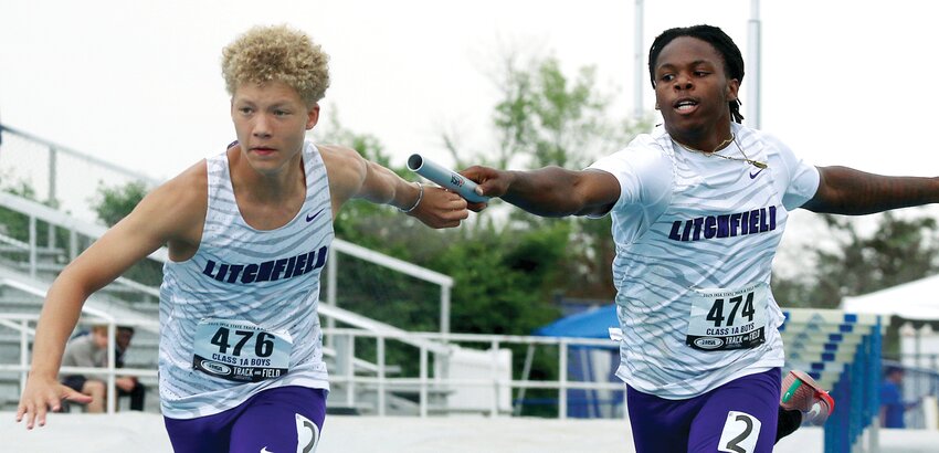 Litchfield's Jaxon Ray reaches back to take the handoff from Martavious Jones during the Panthers' 4x200 meter run at the IHSA State Finals on Thursday, May 29. The pair also ran the 4x100 with teammates Will Cress and Alec Roach, finishing in the program's second fastest time ever, a 43.92.