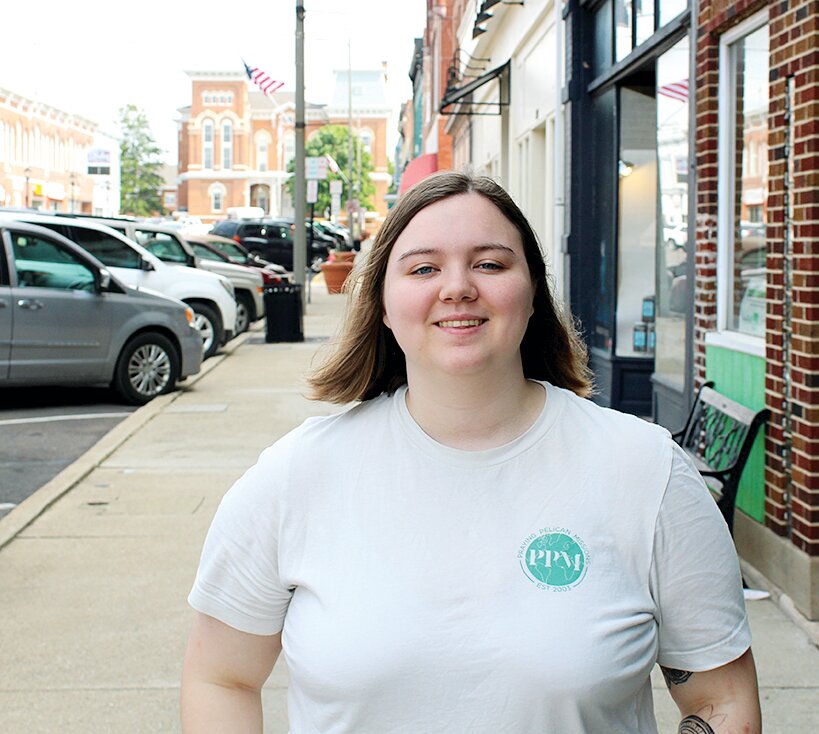 Emma Hughes, assistant trip leader for Praying Pelican Missions, smiles outside of Black Rabbit coffee shop, days before her next mission trip in Tennessee.