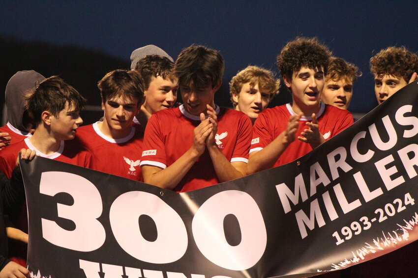 Hillcrest Academy's soccer players celebrate the 300th career win of head coach Marcus Miller after a 2-1 win over Danville on April 18.