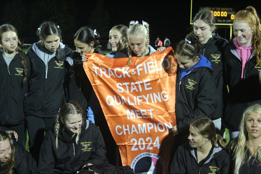 The Mid-Prairie Golden Hawks celebrate winning a district championship in Eddyville.