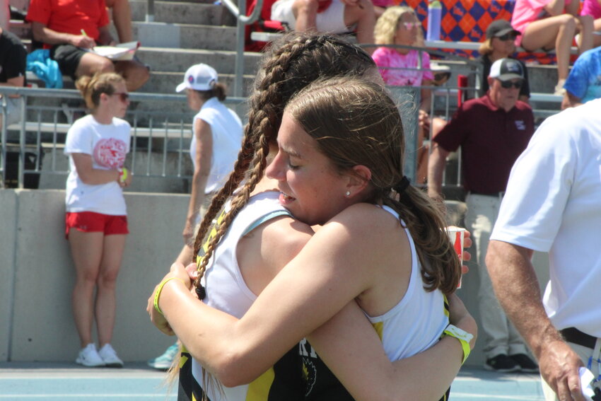 Mid-Prairie seniors Danielle Hostetler and Abby Fleming share an emotional hug following their final high school race together at the Iowa High School Track Championships at Drake Stadium.