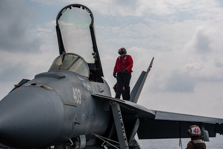 Shirley native checks over a fighter jet aboard USS Theodore Roosevelt ...