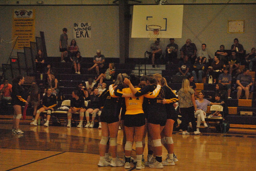 Doyle huddles up before a match this season.