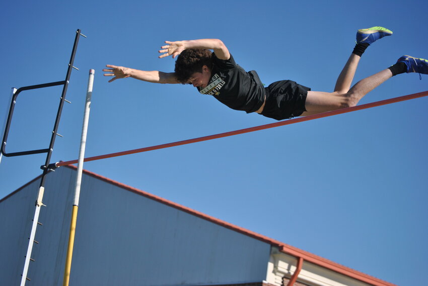 Walker's Eli Hegwood clears the bar in the pole vault at their meet on March 20.