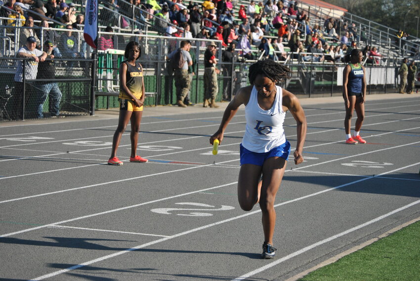 Live Oak's Laila Robertson begins a relay race at Walker on March 20.
