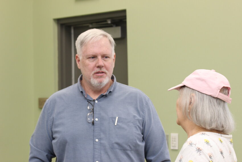 SLU professor Dayne Sherman chats with Kathy Babin at the conclusion of his June 7 talk to the Edward Livingston Historical Association. Sherman outlined the steps he took to solve an old mystery: the identity of his birth parents from Wyoming and how he came to be born in Hammond.