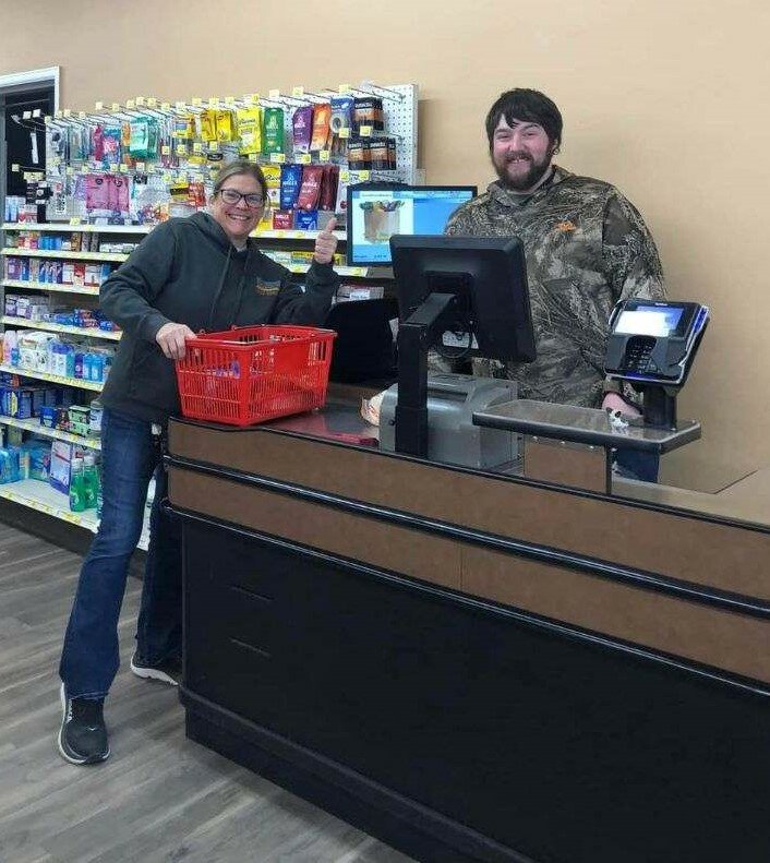 Jate Meyer serves his first customer, Jen Loos.  Meyer officially took ownership of the Goodhue Market grocery store on January 8, 2024.