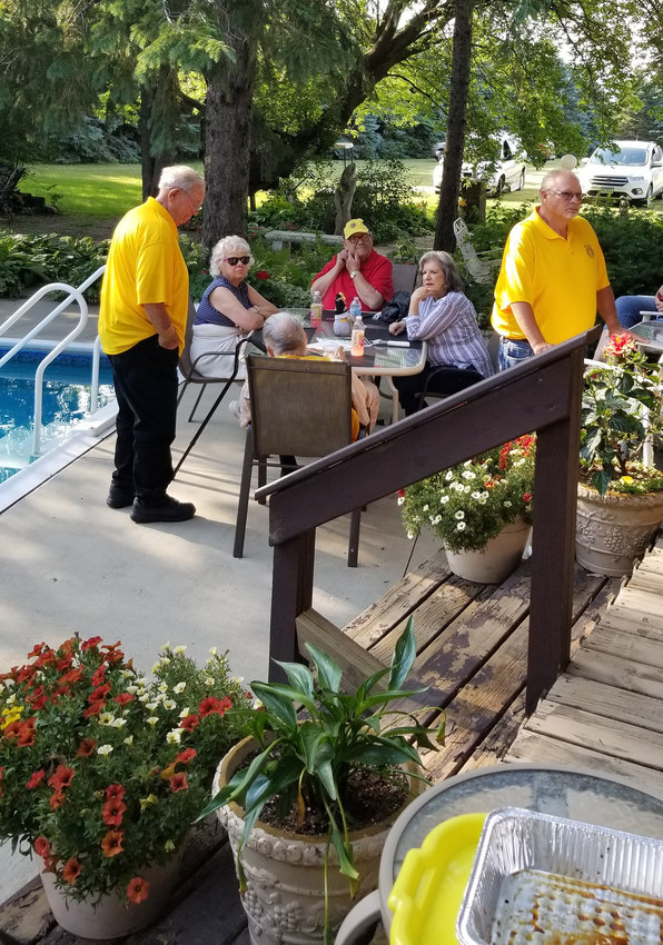 Dodge Center Lions gather at the lovely Deyo home for their annual picnic.