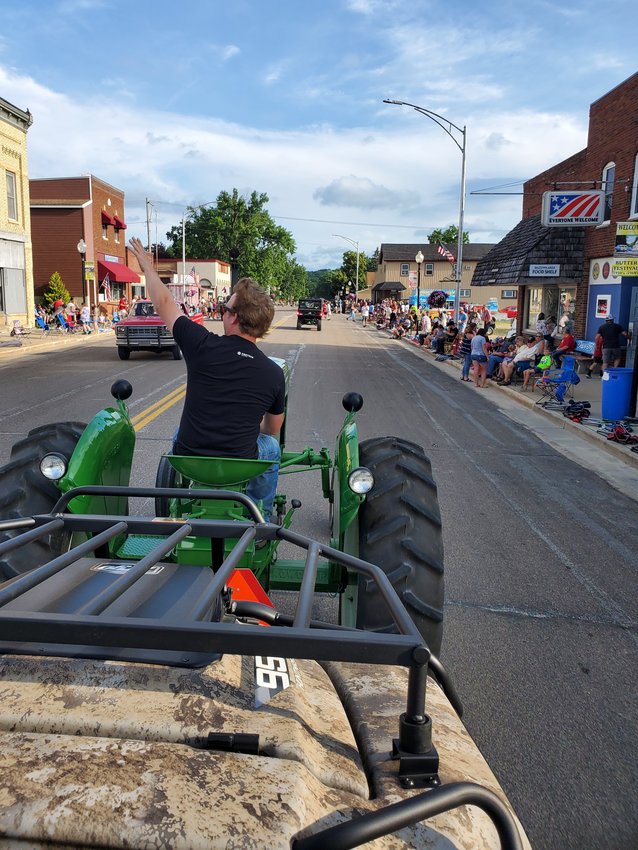 2022 Mazeppa Daze Friday evening headed down to the ballpark to line up for the parade.  Adam Burdick of Zumbrota driving the tractor.