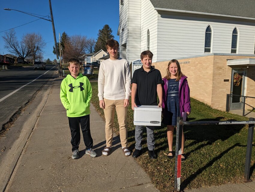 (L-R) Kevin Meyer, Alex Loos, Rhett Miller and Beatrix Miller, members of St. Peter's Sunday School, delivered a Thanksgiving blessings box on November 19th.