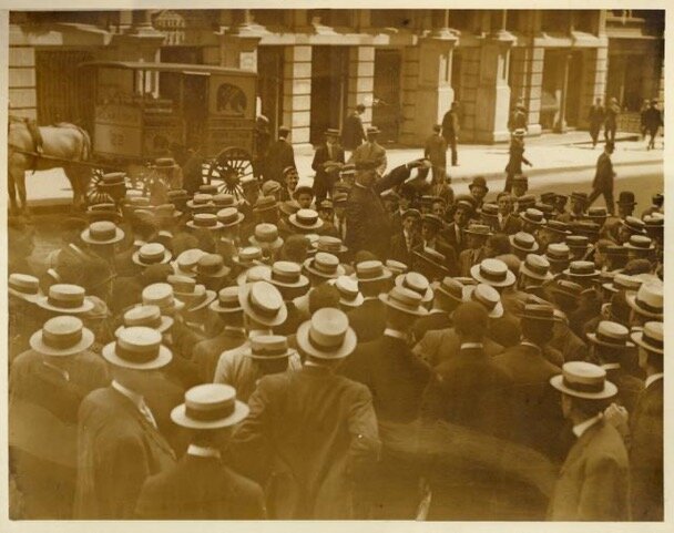 William Wilkinson, standing in the center, preaches on Wall Street