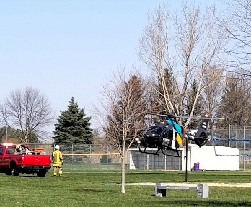 A North Air Medical Helicopter lands in Rosie Park.  Student actor, Jed Ryan was extricated from a car and was lifted and flown in a circle during a mock crash enactment.