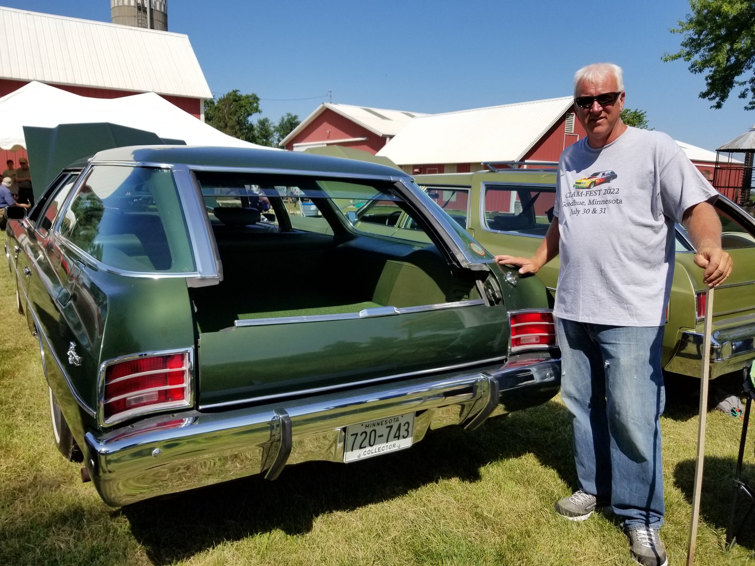 Hilbert Strusz stands next to one of the favorites in his GM Clamshell station wagon collection.  The unique Glide-Away tailgate is shown partially open.  The 1972 Chevrolet Kingswood has only 22,000 miles and its original headlight bulbs and tires.  Strusz hosted the 2nd annual Clam-Fest car show on his farm near Goodhue.