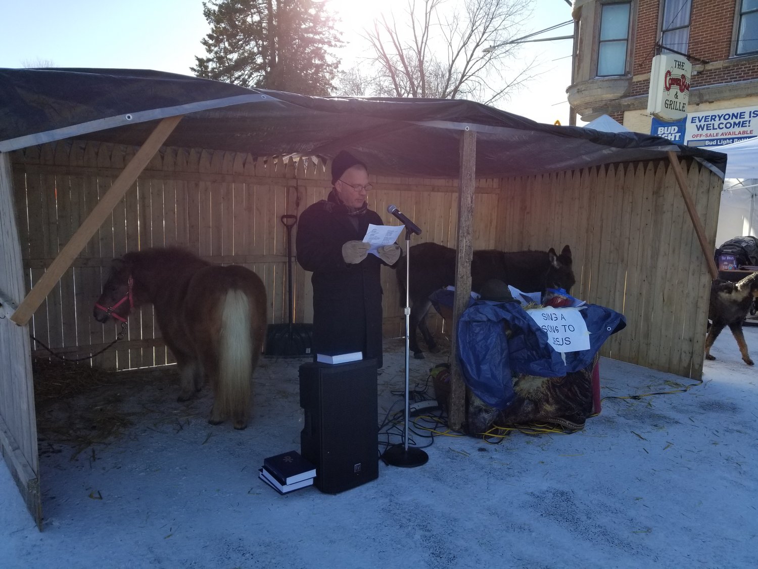 A make-shift stable with a donkey and miniature horse was set up on the South end of 2nd Avenue during the 2nd annual Christkindlmarkt on December 3rd. Pastor Robbin Robbert of St. John’s Lutheran Church, rural Goodhue, encouraged anyone who wanted to sing Christmas carols karaoke style and offered treats to those who participated.