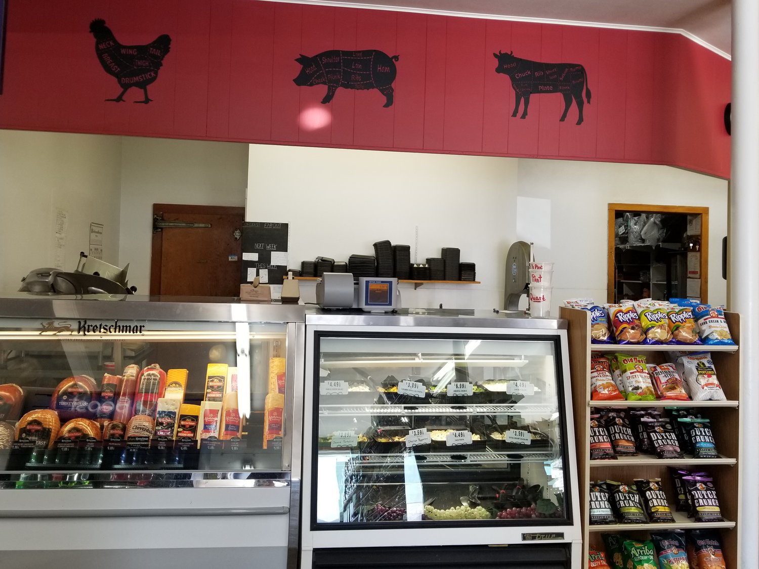 The meat and deli counter has kept its location and favorite items but has an updated look with fresh paint and market silhouettes on the header above.