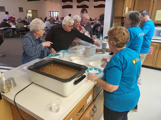 Faith in Action volunteers serving soup at the 2022 Soup and Pie Dinner.