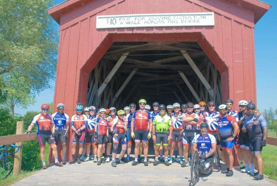 Group in front of covered bridge in Zumbrota