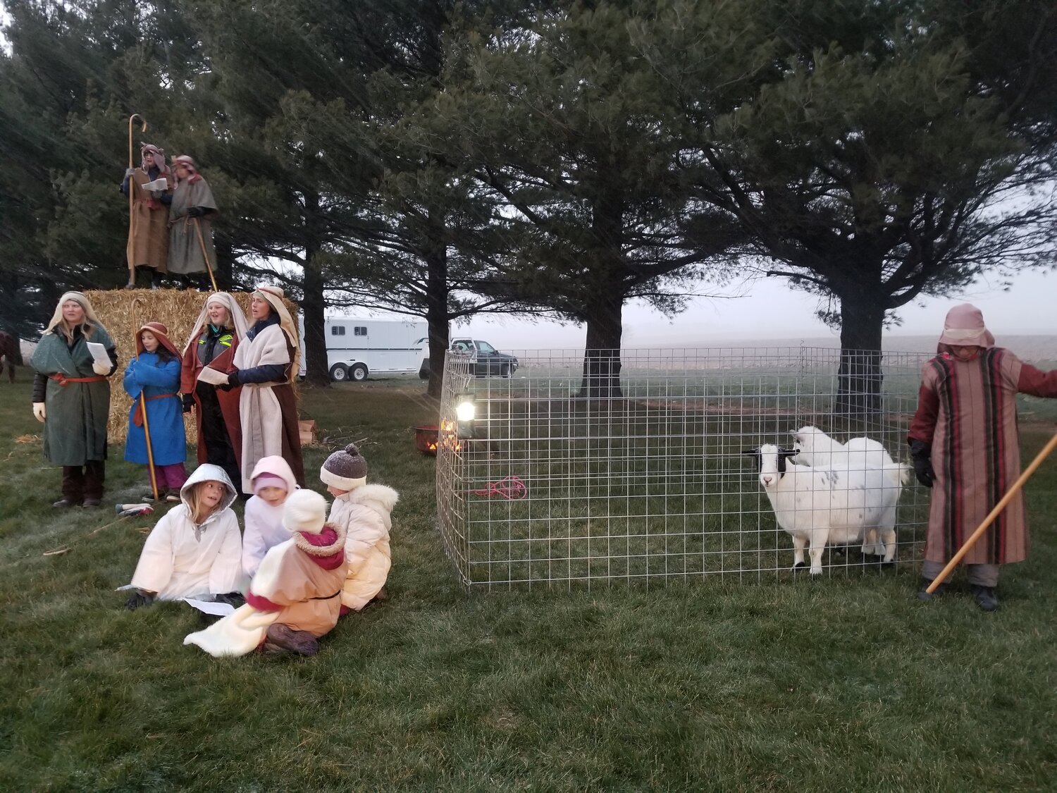 Children and adults dressed in costumes depicting scenes of the Nativity of Christ.  This group of shepherds tend to a pair of goats as snow began to fall on November 25th.