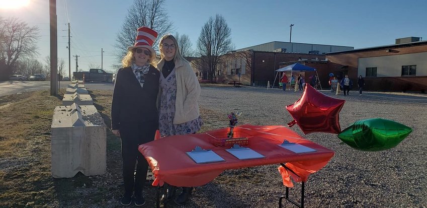 Title 1 Reading Interventionist Cindy Clark and Kindergarten teacher Laurin Wehling register vehicles for raffle prizes.